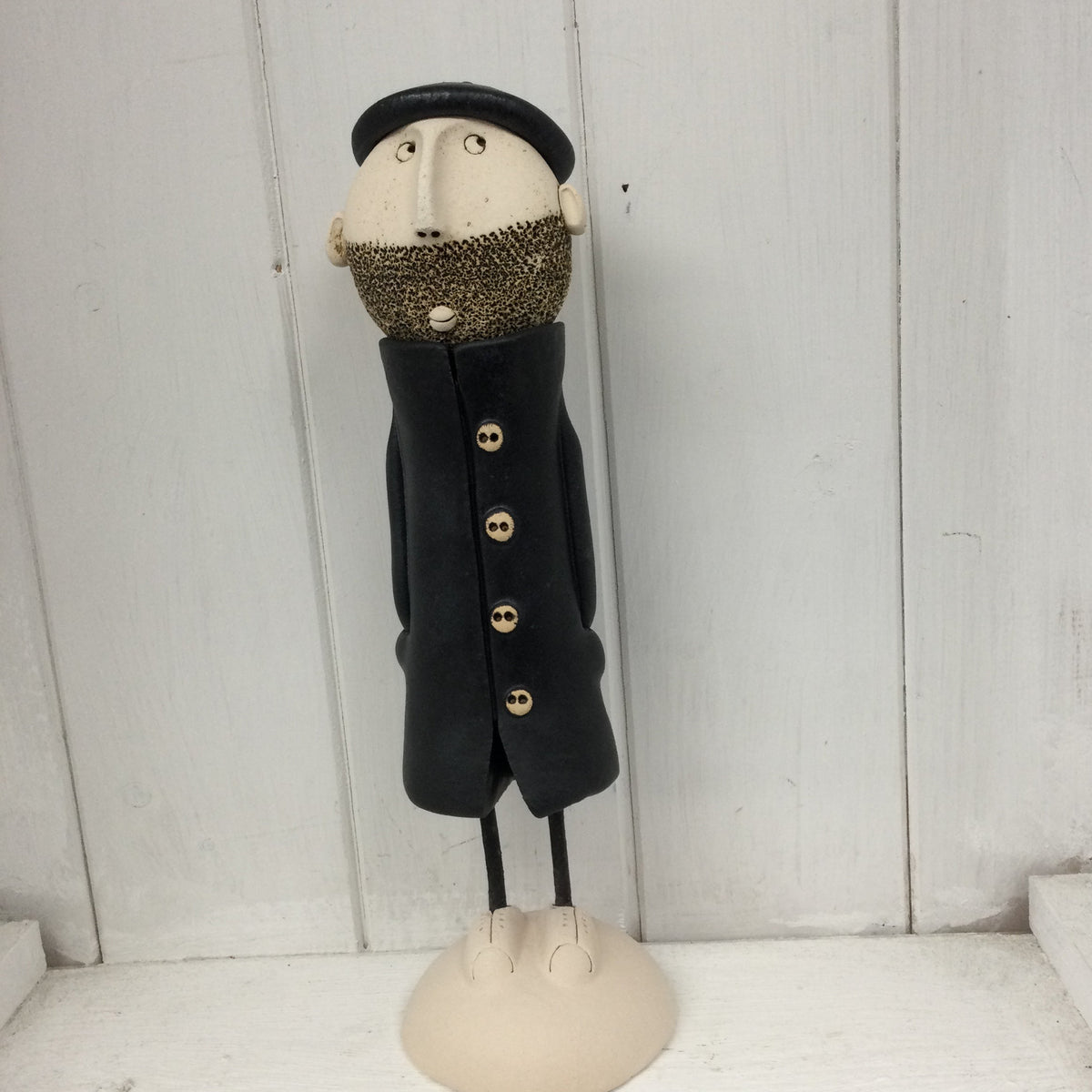 Ceramic Man with beard, beret and a black great coat