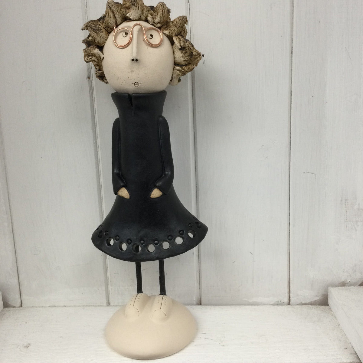 Ceramic Girl with spiky hair and glasses in a black dress