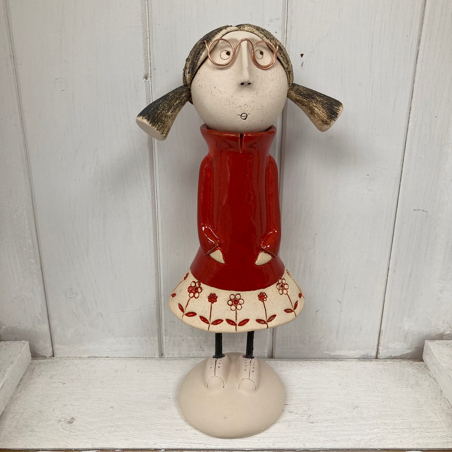 Ceramic Girl with pig tails and glasses in a red dress