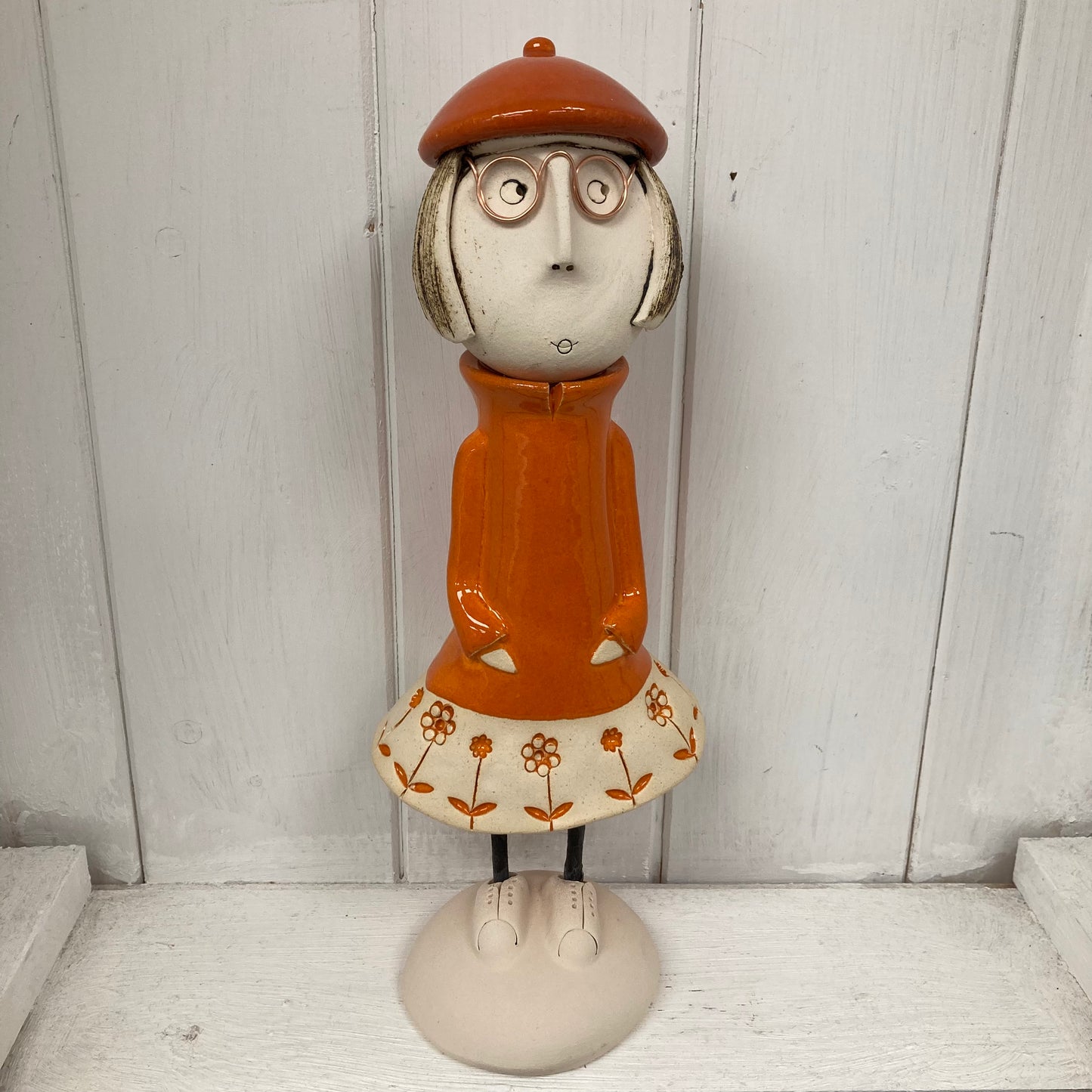 Ceramic Girl with a short Bob in an orange dress