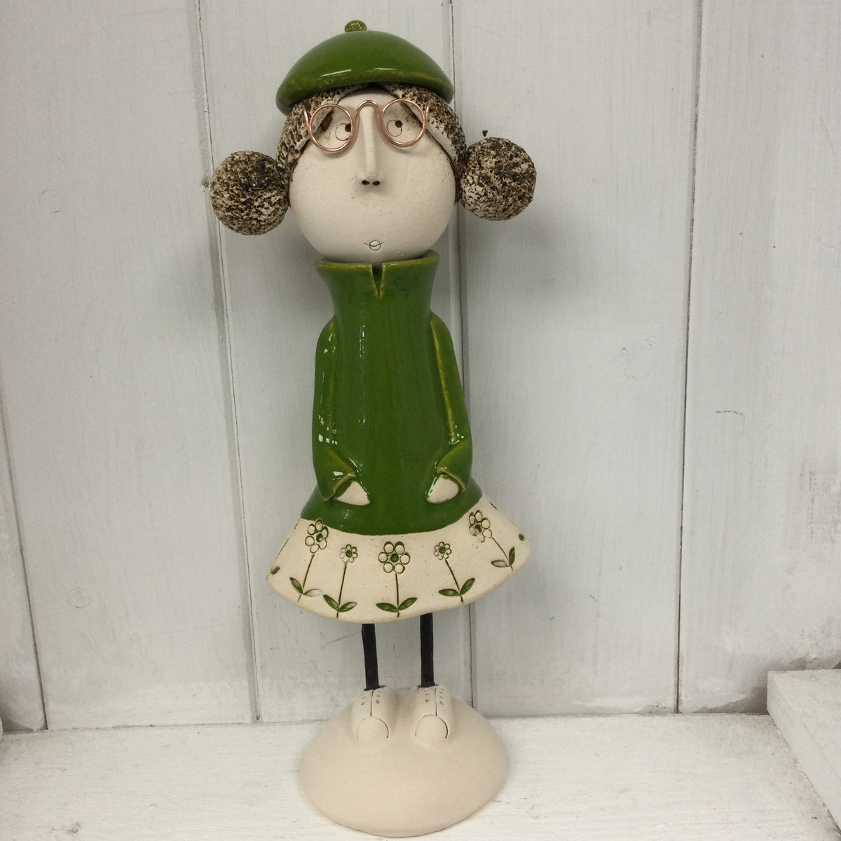 Ceramic Girl with rounded bunches in a green dress
