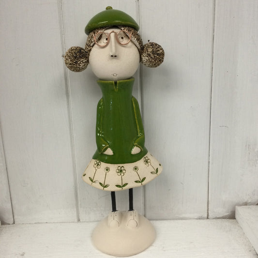 Ceramic Girl with rounded bunches in a green dress